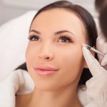 Young woman getting dermal filler cosmetic treatment