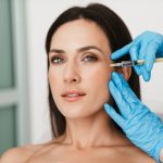 Beautiful woman getting botox for wrinkles and lines.