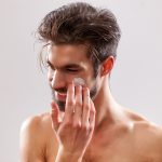 Man applying moisturizer for healthy skin