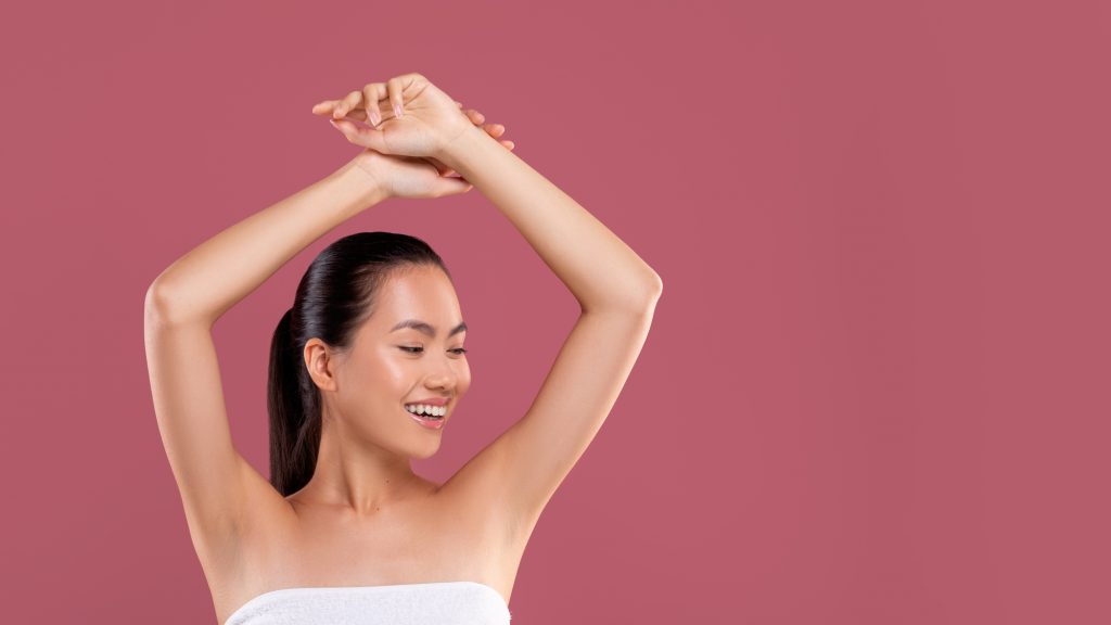 Happy woman showing off smooth underarms. 