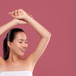 Happy woman showing off smooth underarms.