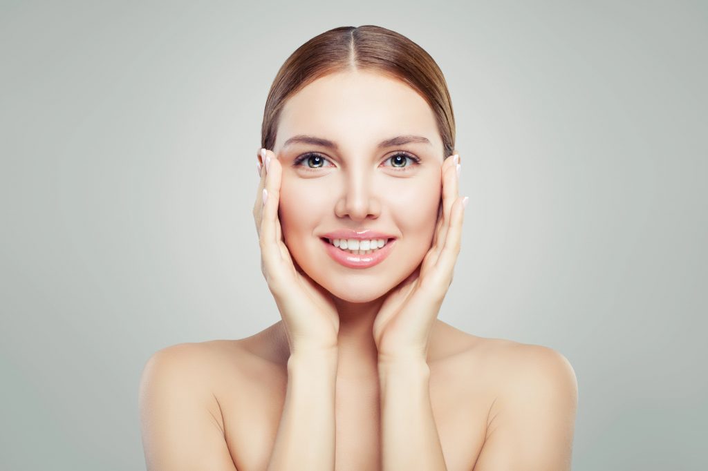 Woman with glowing skin from microneedling. 