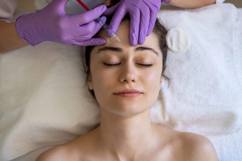 Young woman getting botox maintenance treatment