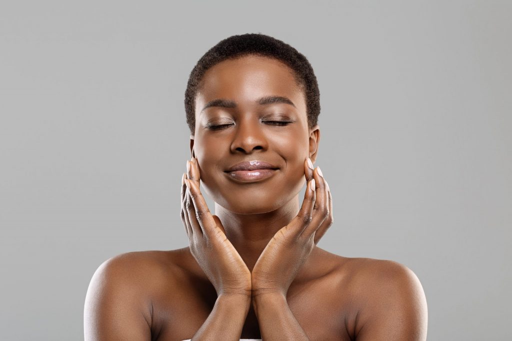 Woman with glowing skin after cosmetic treatment.