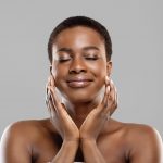 Woman with glowing skin after cosmetic treatment.